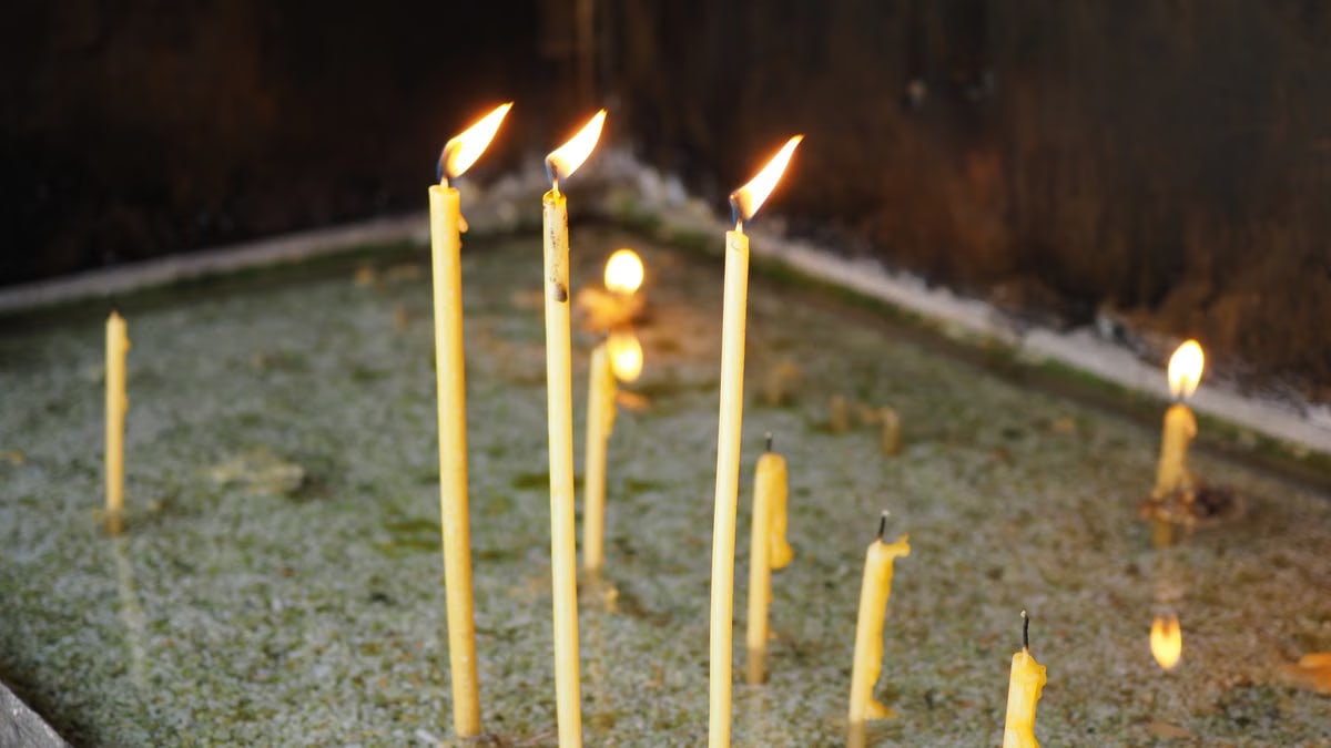 A serene close-up of burning candles in a peaceful, contemplative environment.